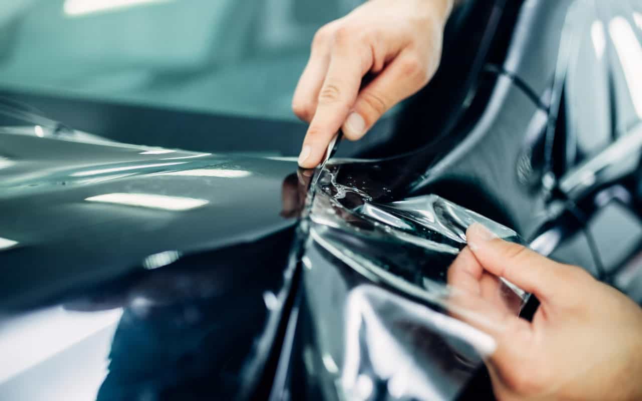 Kreasion Worker Installing Car Protection Film Clear Mask